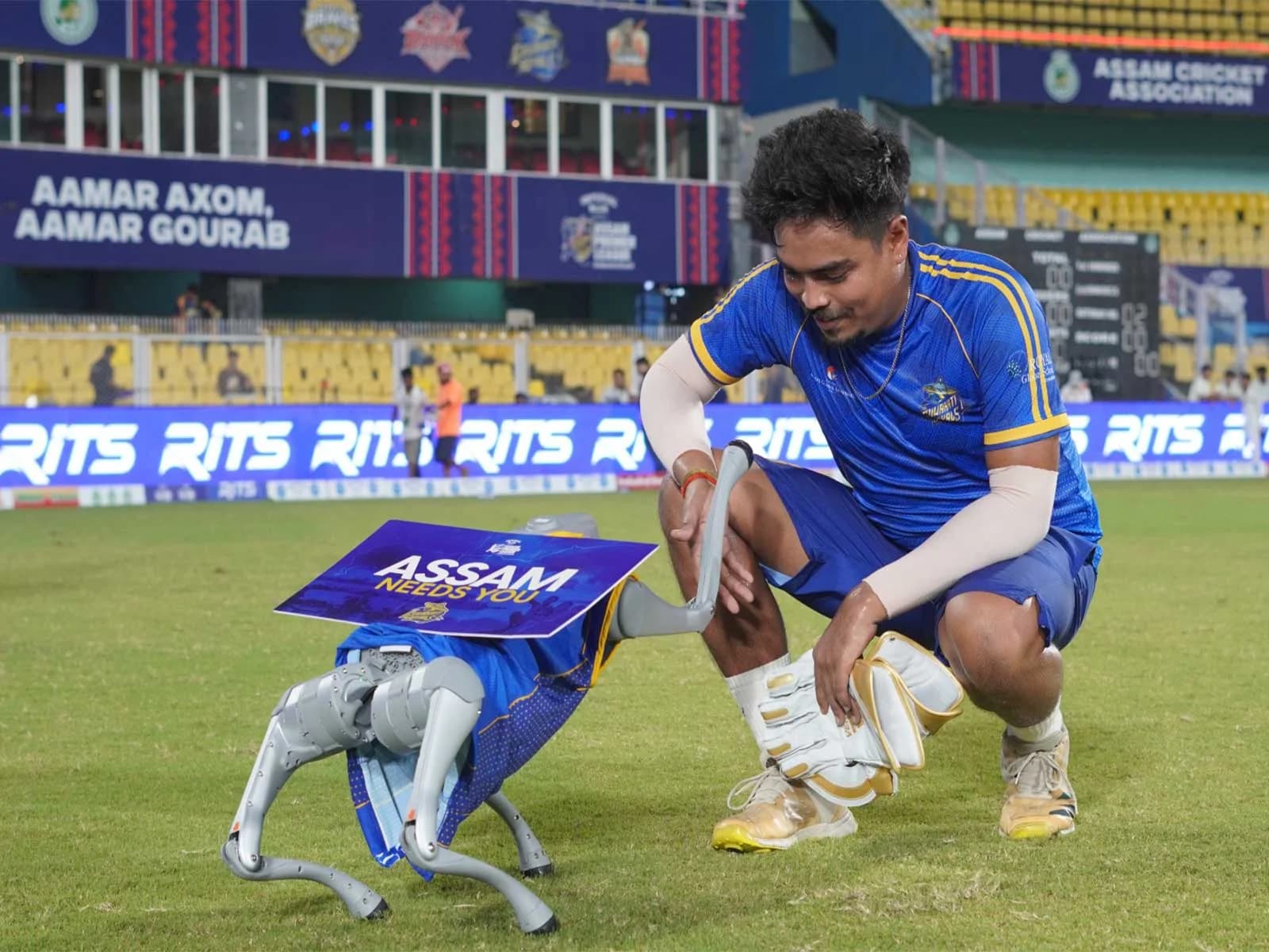 RoboDog Carries ‘Assam Needs You’ Message at Assam Premier League Match to Highlight Flood Relief