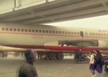 Decommissioned plane stuck under bridge