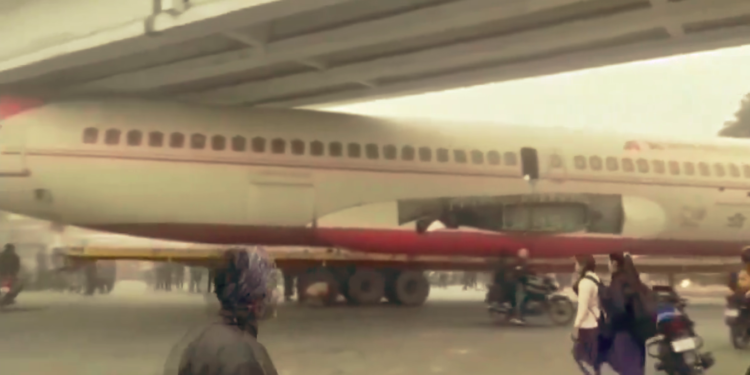 Decommissioned plane stuck under bridge